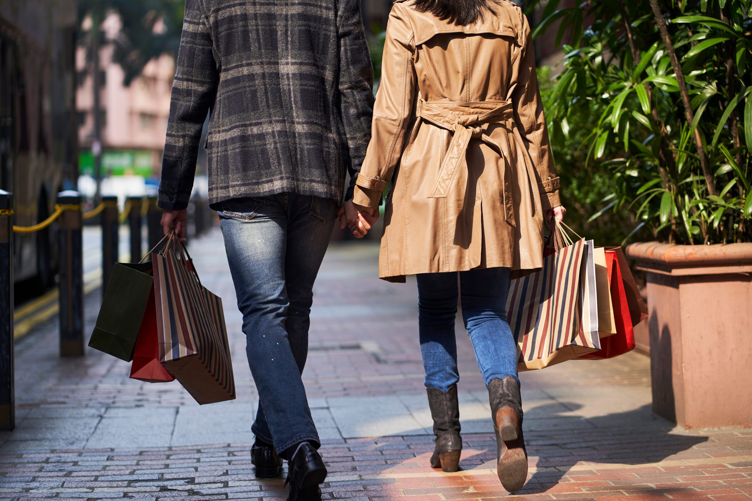Rear,View,Of,Young,Asian,Couple,Walking,On,Street,With